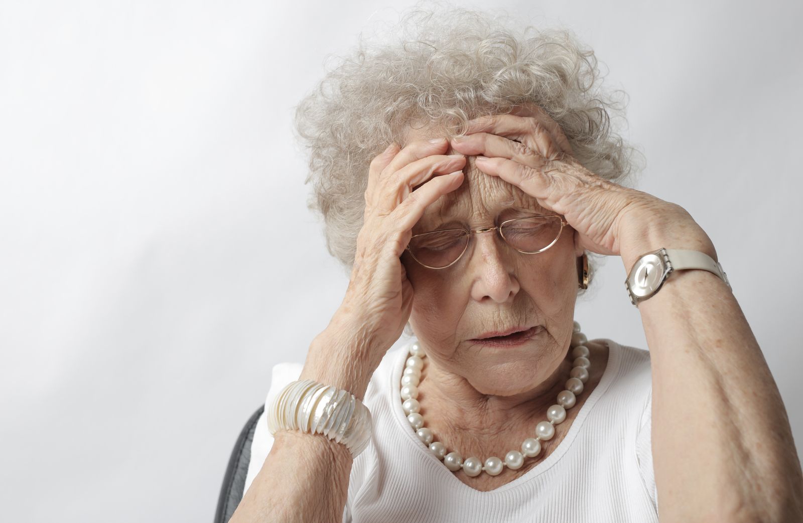 Older woman holding her head during a dizzy spell
